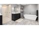 Modern bathroom featuring a floating vanity, soaking tub, and walk-in closet at 1 Club Ln, Littleton, CO 80123
