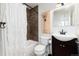 Bathroom with white shower curtain, dark vanity, and framed giraffe art at 1 Club Ln, Littleton, CO 80123