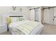 Bright bedroom with a barn door leading to the ensuite bath and giraffe artwork at 1 Club Ln, Littleton, CO 80123