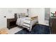 Bedroom with brass bed frame, navy patterned rug, and wood nightstand at 1 Club Ln, Littleton, CO 80123