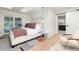 Bright bedroom with light wood floors, ensuite bathroom, and sliding glass door at 1 Club Ln, Littleton, CO 80123