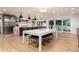 Open-concept dining area with modern table, chairs, and stylish lighting adjacent to the kitchen area at 1 Club Ln, Littleton, CO 80123