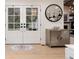 Elegant foyer featuring a double-door entry, stylish cabinet, wood flooring, and contemporary decor at 1 Club Ln, Littleton, CO 80123