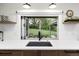 Gourmet kitchen sink and counter space with bi-fold windows leading to backyard living at 1 Club Ln, Littleton, CO 80123