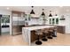 Spacious kitchen boasts waterfall island, stainless steel appliances, and eat-in bar at 1 Club Ln, Littleton, CO 80123