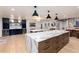 Open floor plan with kitchen island with stone accent, bar, dining, and elegant cabinetry at 1 Club Ln, Littleton, CO 80123