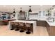 Modern kitchen with a large island, countertop seating, stainless steel appliances, and sleek cabinetry at 1 Club Ln, Littleton, CO 80123