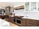 Gourmet kitchen features stainless steel appliances, custom cabinets and eat-in island at 1 Club Ln, Littleton, CO 80123