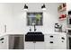 Modern kitchen with stainless steel appliances, white cabinetry, and a farmhouse sink at 1 Club Ln, Littleton, CO 80123