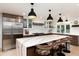 Spacious kitchen boasts waterfall island, stainless steel appliances, and eat-in bar at 1 Club Ln, Littleton, CO 80123
