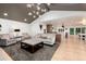 Open-concept living room with high ceilings, stylish furniture, and a kitchen bar at 1 Club Ln, Littleton, CO 80123