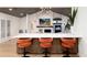 Open floor plan with kitchen bar, fireplace, and large screen TV in the living room at 1 Club Ln, Littleton, CO 80123