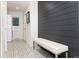 Mudroom featuring a patterned tile floor, bench seating, and horizontal wood accent wall at 1 Club Ln, Littleton, CO 80123