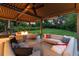 Outdoor living space with comfortable seating around a modern fire pit and a ceiling fan at 1 Club Ln, Littleton, CO 80123