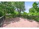 Spacious wooden back deck surrounded by lush greenery, perfect for outdoor enjoyment at 5355 S Windermere St, Littleton, CO 80120