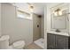 Modern bathroom with tiled shower, updated vanity, and neutral color palette at 5355 S Windermere St, Littleton, CO 80120
