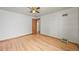 Bright bedroom features hardwood floors, neutral walls, and a ceiling fan at 5355 S Windermere St, Littleton, CO 80120