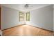 Bedroom with hardwood floors, light walls, and two windows allowing natural light at 5355 S Windermere St, Littleton, CO 80120
