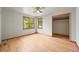 Bright, sunny bedroom featuring hardwood floors, fresh paint, large windows, and closet at 5355 S Windermere St, Littleton, CO 80120