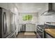 Modern kitchen with stainless steel appliances, white subway tile backsplash, and updated cabinetry at 5355 S Windermere St, Littleton, CO 80120