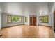 Spacious living room with hardwood floors, large windows, and ample natural light at 5355 S Windermere St, Littleton, CO 80120