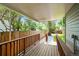 Covered patio with wooden railing overlooking landscaped backyard at 5355 S Windermere St, Littleton, CO 80120