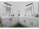 Well-lit bathroom with dual vanities and modern mirrors at 9877 Arthur Ln, Highlands Ranch, CO 80130