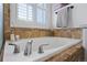 Close-up of tub with tiled surround and chrome fixtures at 9877 Arthur Ln, Highlands Ranch, CO 80130