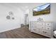 Bright bedroom with white walls, wood-look floors, and a wall-mounted TV at 9877 Arthur Ln, Highlands Ranch, CO 80130