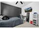 Modern bedroom with a dark accent wall, wall mounted TV, desk, and contemporary decor at 9877 Arthur Ln, Highlands Ranch, CO 80130
