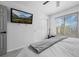 Bright bedroom with mounted television, closet, and large window at 9877 Arthur Ln, Highlands Ranch, CO 80130