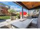 Outdoor patio featuring a fire table, seating, and open backyard space, ideal for entertaining at 9877 Arthur Ln, Highlands Ranch, CO 80130
