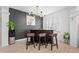 Dining area features a bar, accent wall, modern lighting, and wooden stools, perfect for entertaining and casual dining at 9877 Arthur Ln, Highlands Ranch, CO 80130
