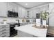 Well-lit kitchen featuring stainless appliances, ample counter space and updated cabinetry at 9877 Arthur Ln, Highlands Ranch, CO 80130