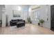 Comfortable living room with a plush sofa, ottoman, and large windows, offering a cozy and bright space at 9877 Arthur Ln, Highlands Ranch, CO 80130