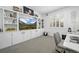 Well-lit home office features a built-in wall unit and a neutral color palette at 9877 Arthur Ln, Highlands Ranch, CO 80130