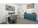 Bright home office space featuring a computer desk, gray office chair, and modern artwork at 9877 Arthur Ln, Highlands Ranch, CO 80130