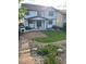 Beautiful backyard featuring lush green grass, stone steps, and a covered patio at 2853 Black Canyon Way, Castle Rock, CO 80109