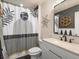 This modern bathroom boasts a stylish vanity, decorative mirror, and patterned shower curtain for a contemporary feel at 2853 Black Canyon Way, Castle Rock, CO 80109