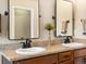 Bathroom with double sinks, granite countertops, wood cabinets, and modern finishes at 2853 Black Canyon Way, Castle Rock, CO 80109
