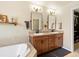 Bathroom featuring double sinks, granite countertops, and tile surround on the soaking tub at 2853 Black Canyon Way, Castle Rock, CO 80109