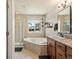 Bright bathroom featuring a tiled shower, soaking tub with garden view, and granite vanity at 2853 Black Canyon Way, Castle Rock, CO 80109