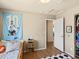 Bright bedroom featuring wood floors, neutral walls, soccer-themed decor, and access to a walk-in closet at 2853 Black Canyon Way, Castle Rock, CO 80109