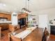 Bright dining room features hardwood floors, large table, modern light fixture, and open access to the kitchen at 2853 Black Canyon Way, Castle Rock, CO 80109