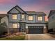Charming two-story home boasting a well-manicured lawn, dark trim, and a spacious two-car garage at 2853 Black Canyon Way, Castle Rock, CO 80109