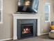 Living room with a modern fireplace, tile surround, and decorative mantle at 2853 Black Canyon Way, Castle Rock, CO 80109