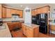 Well-lit kitchen boasts wood cabinets, granite counters, stainless appliances, and an island at 2853 Black Canyon Way, Castle Rock, CO 80109