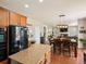 Modern kitchen with stainless steel appliances, granite countertops, hardwood floors, and open access to the dining room at 2853 Black Canyon Way, Castle Rock, CO 80109