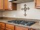Kitchen with granite countertops, gas range, decorative backsplash, and wooden cabinetry at 2853 Black Canyon Way, Castle Rock, CO 80109