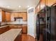 Modern kitchen with stainless steel appliances, wood cabinets, granite countertops, and a kitchen island at 2853 Black Canyon Way, Castle Rock, CO 80109